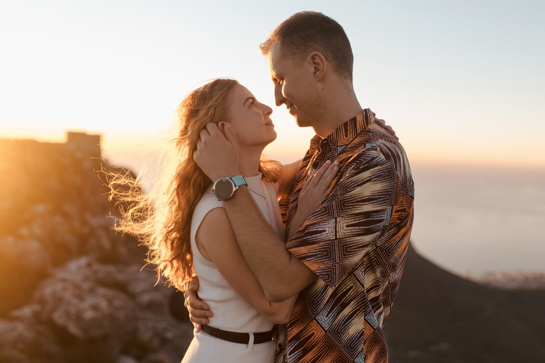 Jason and Riancha forehead to forehead at golden hour on the mountain